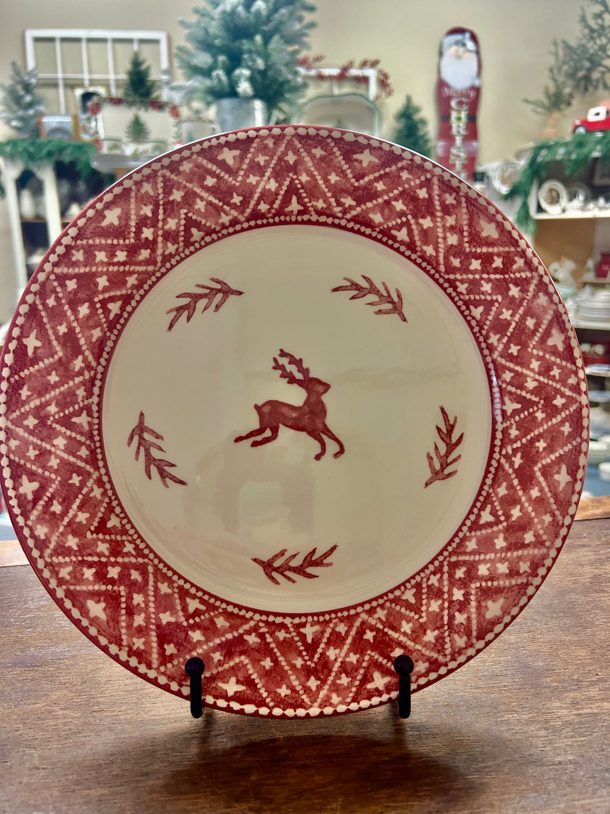 Red Nordic-style dinner plate with reindeer and red border pattern on cream background