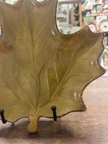 Gold-green leaf-shaped ceramic plate with glossy rim and two metal display hooks
