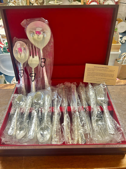 Silverware set in gift box with wrapped serving spoons and forks