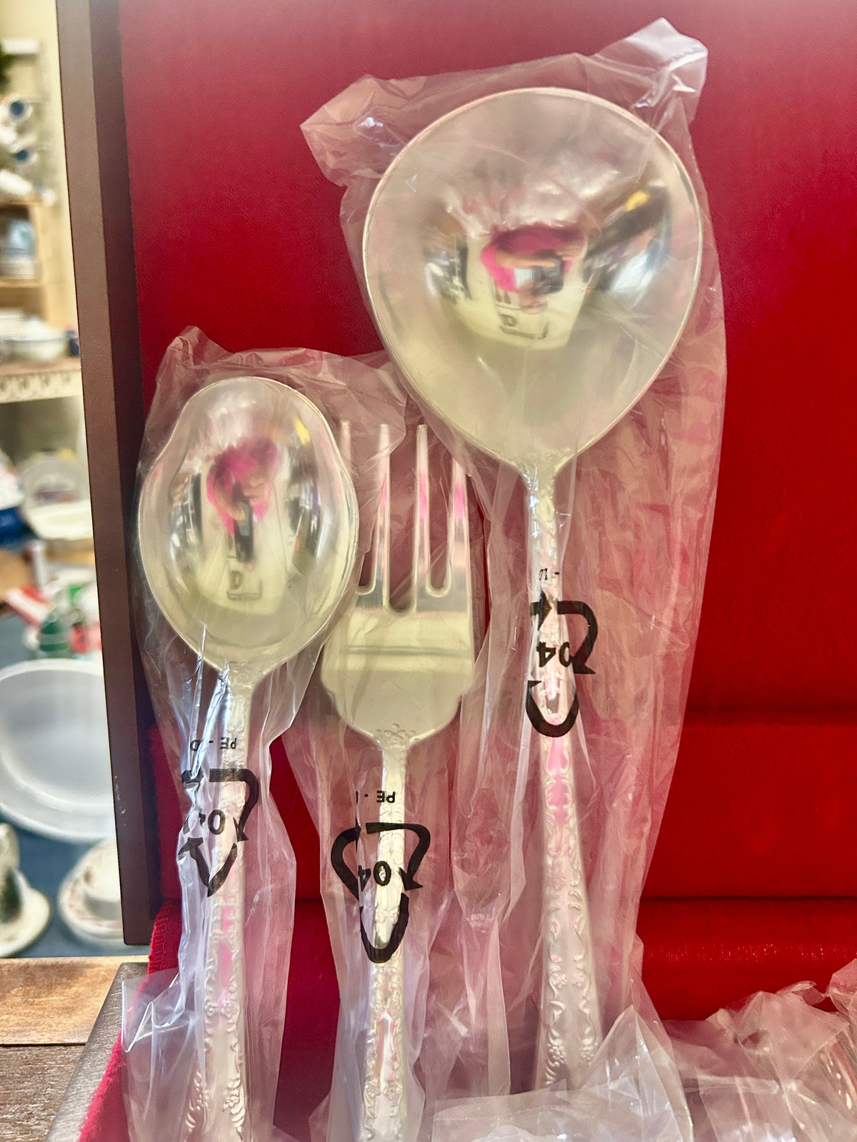 Silverware set spoon and fork with floral rose pattern, wrapped in plastic