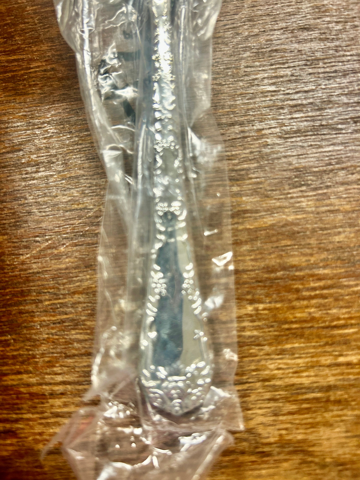 Wrapped silverware handle with floral engraving detail
