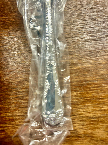 Wrapped silverware handle with floral engraving detail