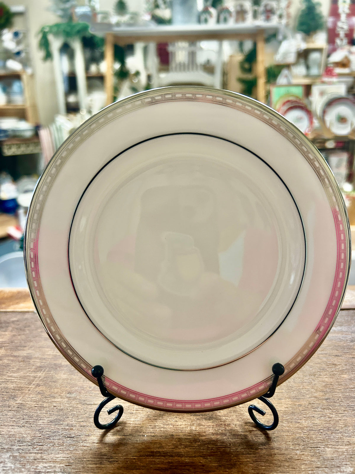White bread plate with silver-tone rim, pink stripe, and black inner ring