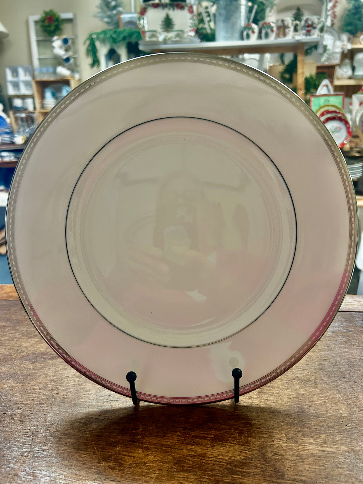 White ceramic dinner plate with silver-toned rim and decorative outer edge