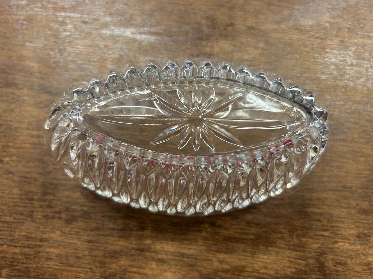 Clear crystal silverware holder with scalloped top edge and faceted sides