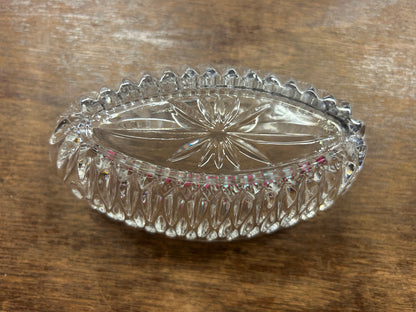 Clear crystal silverware holder with scalloped top edge and faceted sides