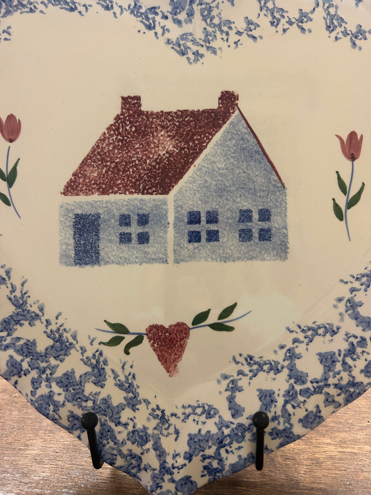 Heart-shaped sponge platter with blue speckled edges, red house, and blue heart accents.