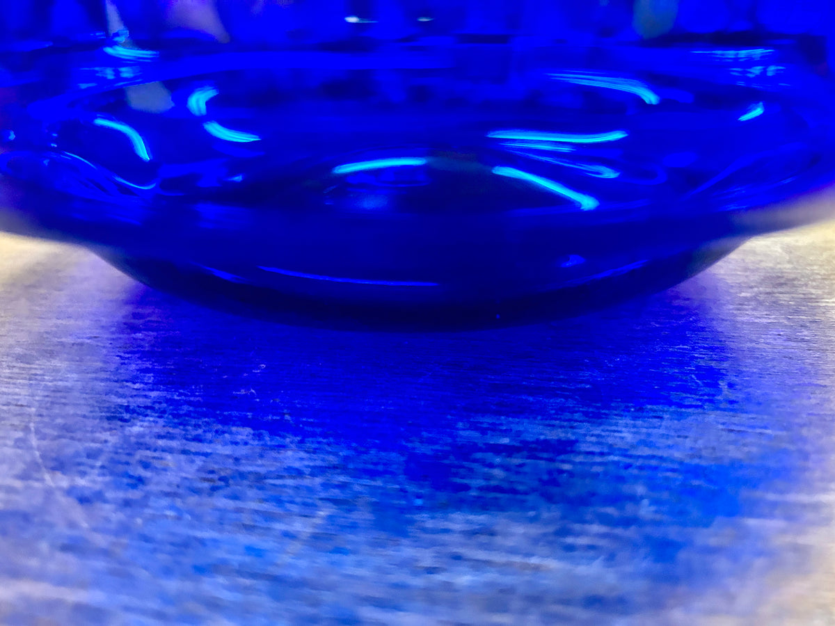 Cobalt blue footed bowl close-up of curved rim and glossy interior