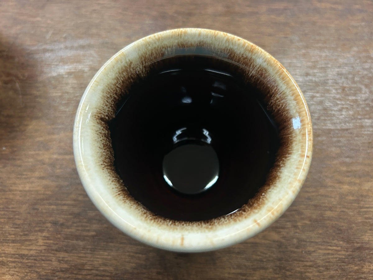 Brown glazed custard cup interior with mottled drip pattern around the rim