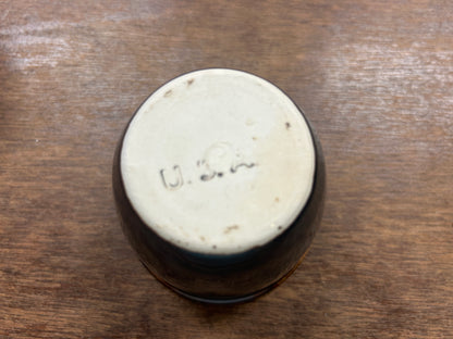 Bottom of brown glazed custard cup with stamped markings