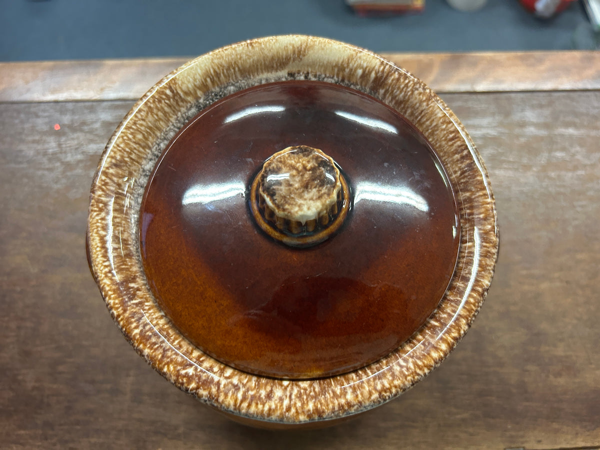Brown ceramic lid underside with central knob and speckled edge, 7 in