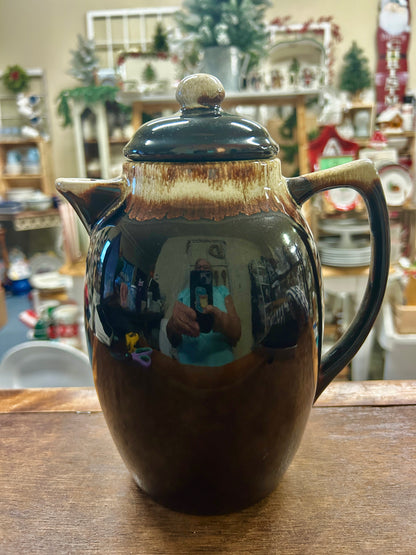 Brown ceramic drip coffee pot with dark teal lid and knob, side handle