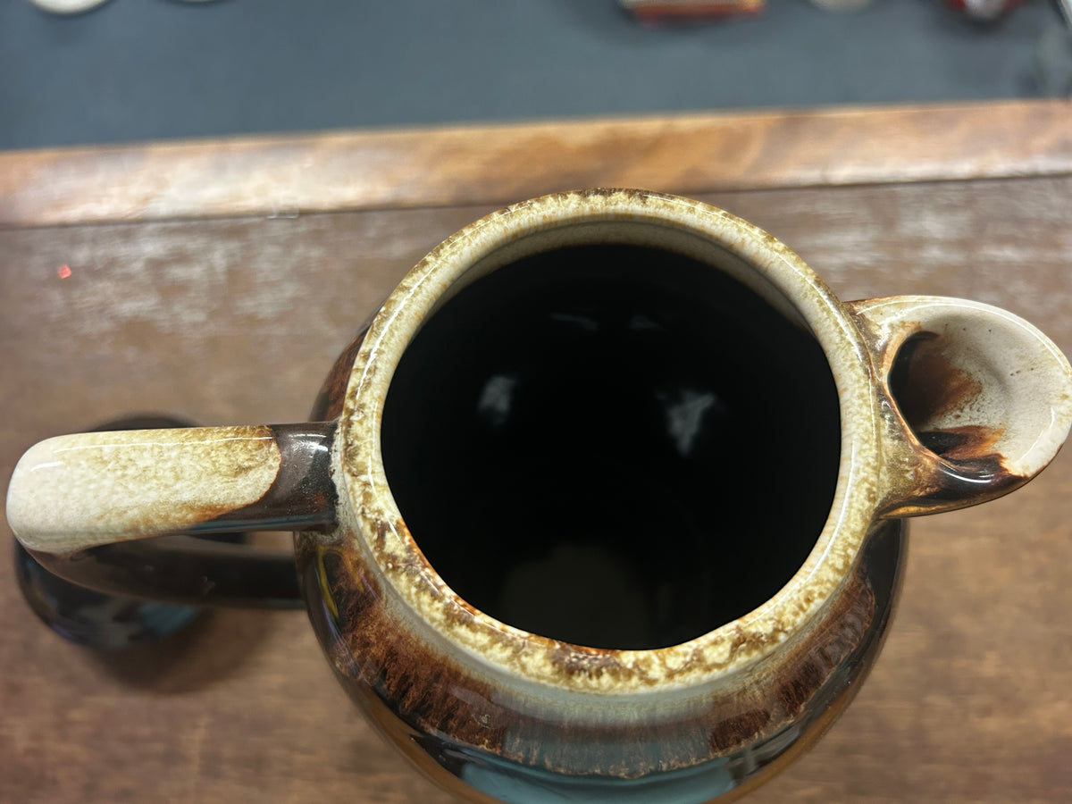 Brown ceramic drip coffee pot open top, dark interior and speckled rim