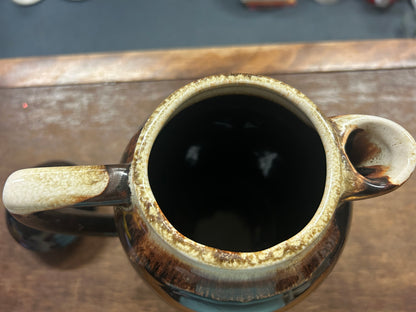 Brown ceramic drip coffee pot open top, dark interior and speckled rim