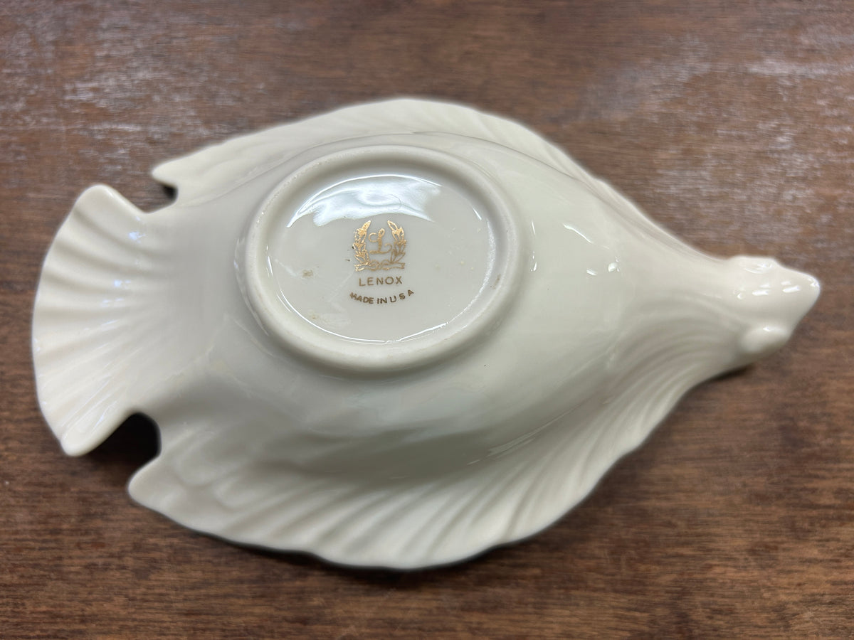 Cream Lenox dove bowl base with centered logo medallion and gold lettering.