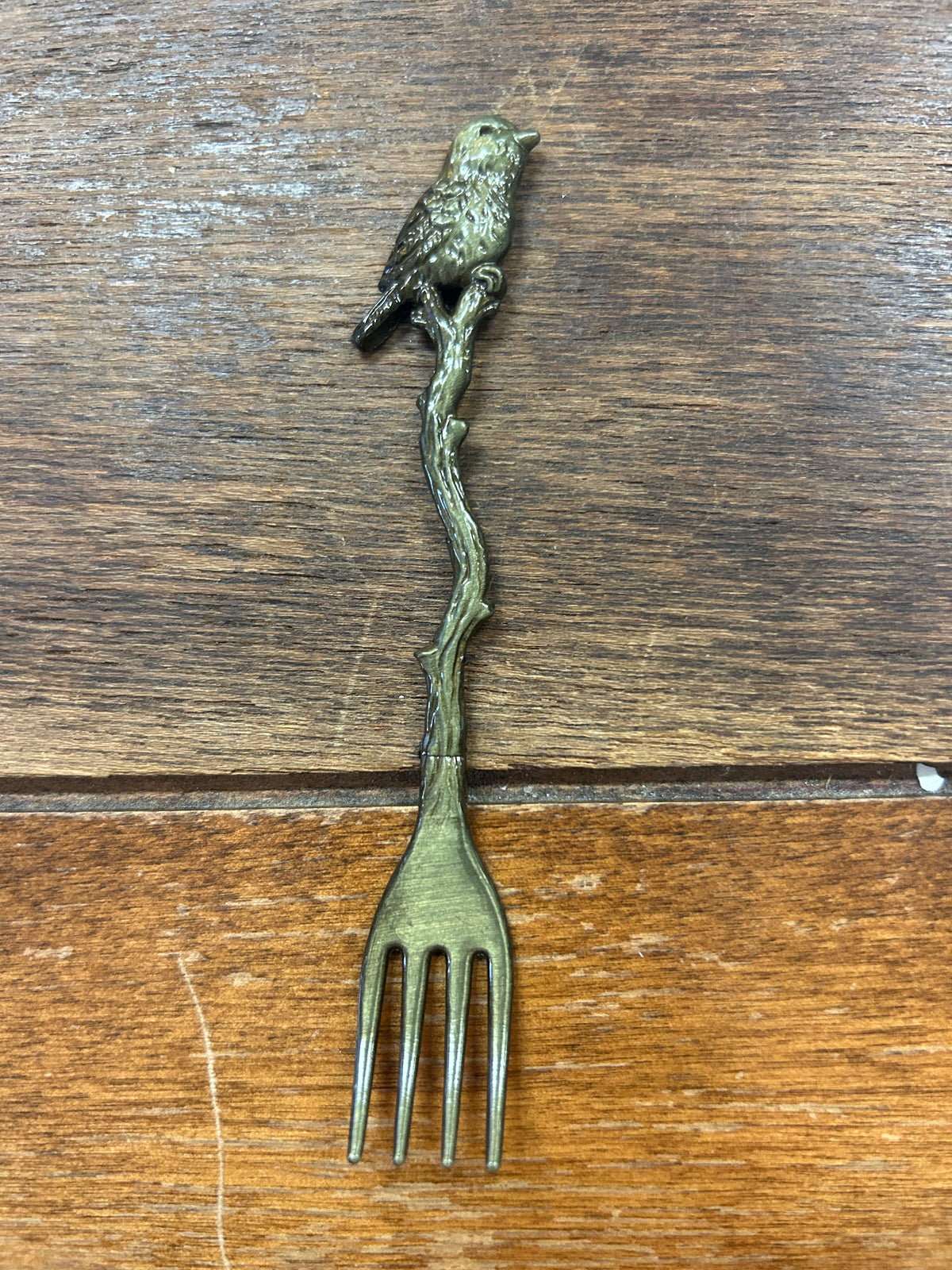 Bronze-toned bird cocktail fork with bird perched on handle and four tines