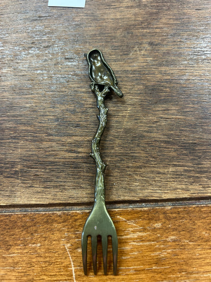 Bronze-toned bird cocktail fork with four tines and bird detail on stem