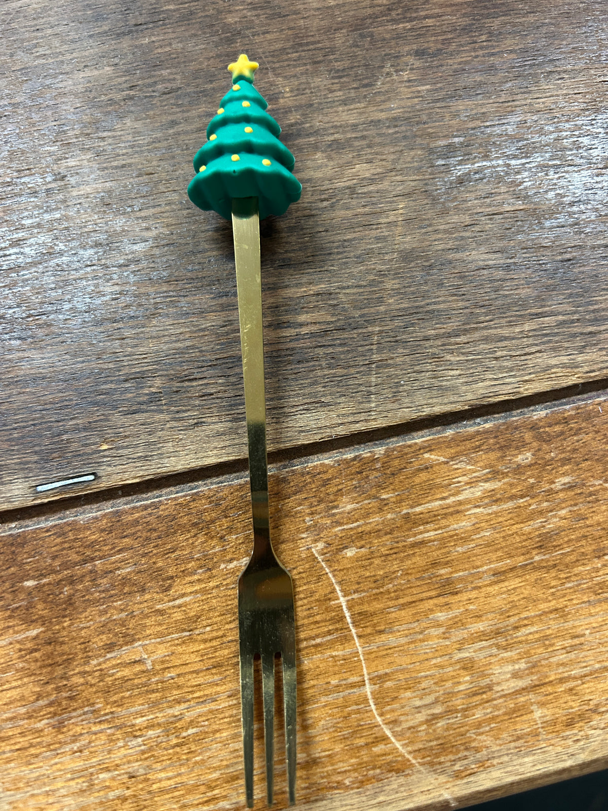 Christmas tree cocktail fork with gold handle and green enamel tree topper