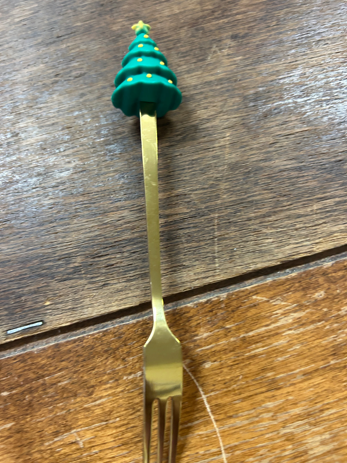 Gold cocktail fork with green Christmas tree finial and two-prong tip