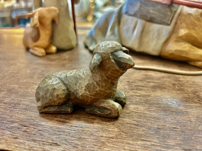 Cream animal figurine lying on side, detailed textured surface