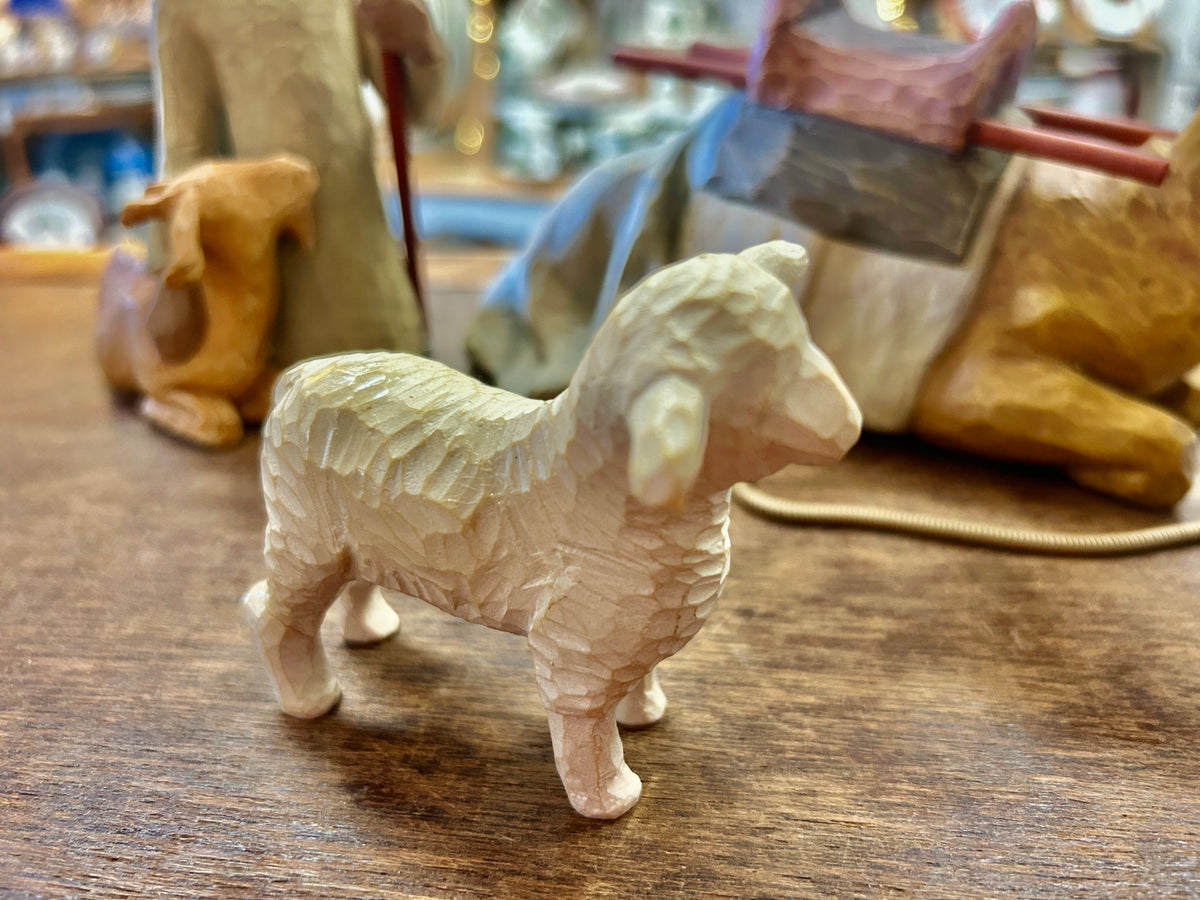 Cream sheep figurine standing, with seated shepherd and staff behind