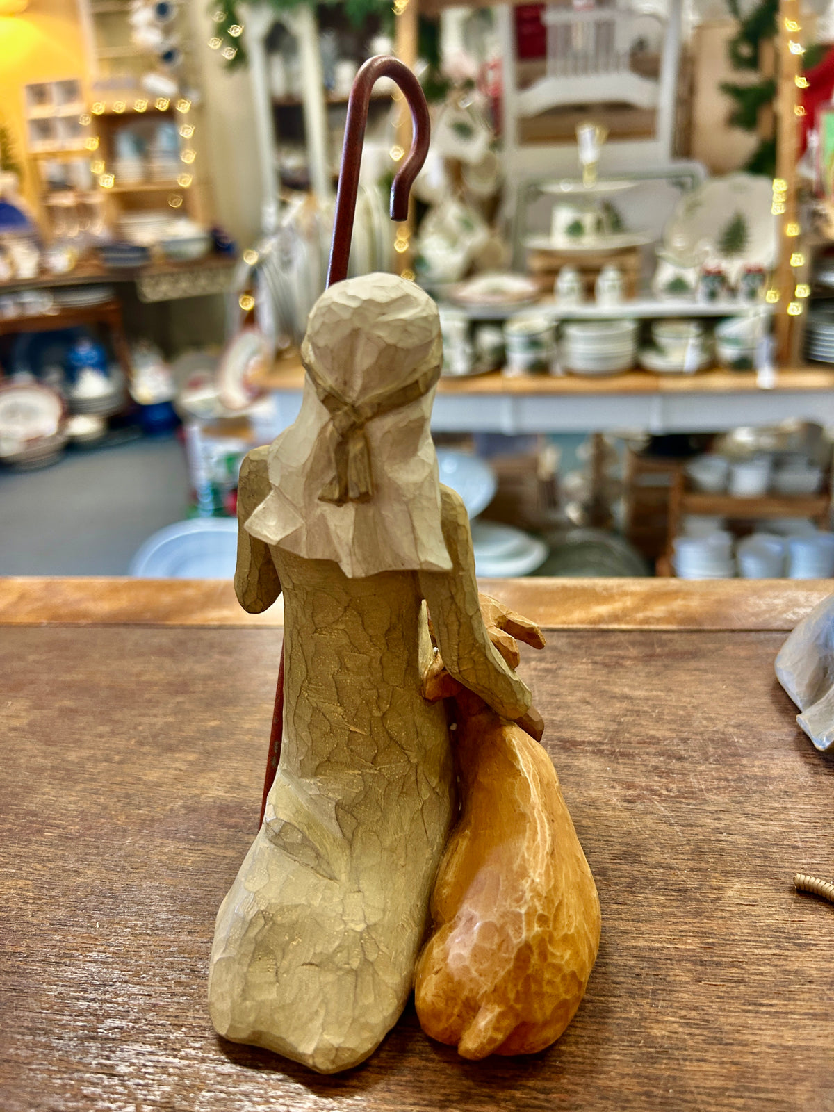 Cream shepherd figurine standing, holding curved staff, long robe and bow