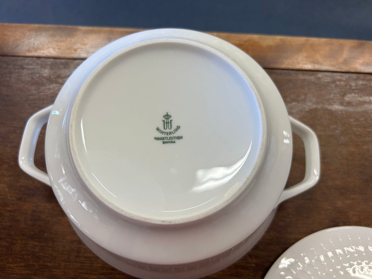 White casserole base with handles; lid underside shows Winterling logo