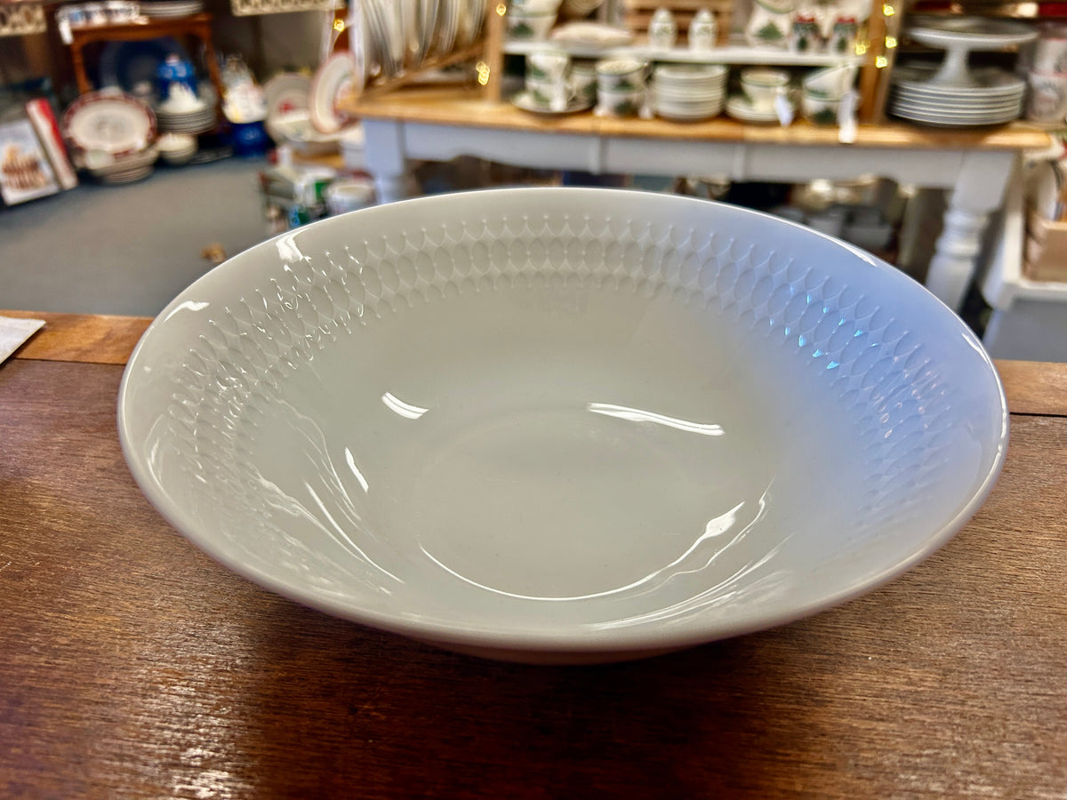 White serving bowl with embossed texture on the rim