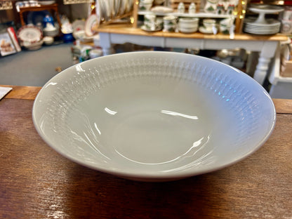 White serving bowl with embossed texture on the rim