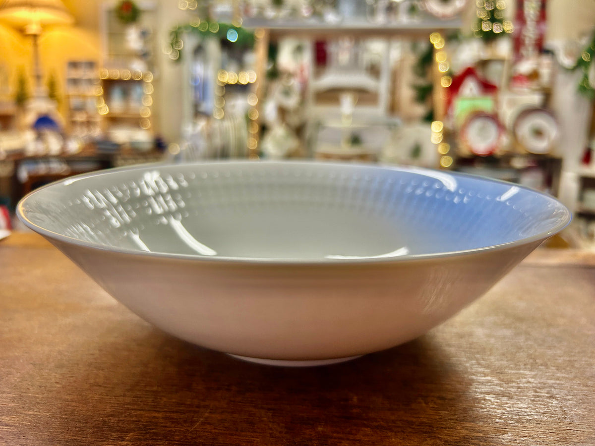 White serving bowl with glossy finish and shallow rim, textured surface pattern