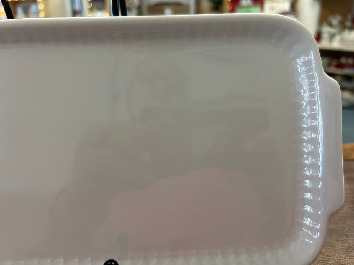 White rectangular ceramic platter close-up of right raised rim