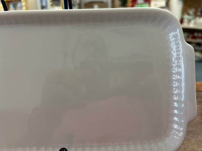 White rectangular ceramic platter close-up of right raised rim