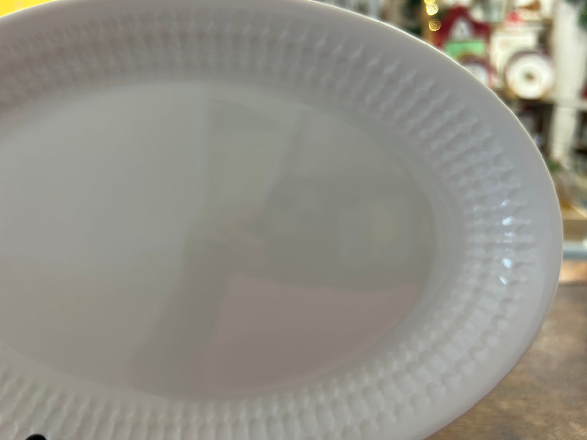 White oval platter with embossed edge and shallow center well