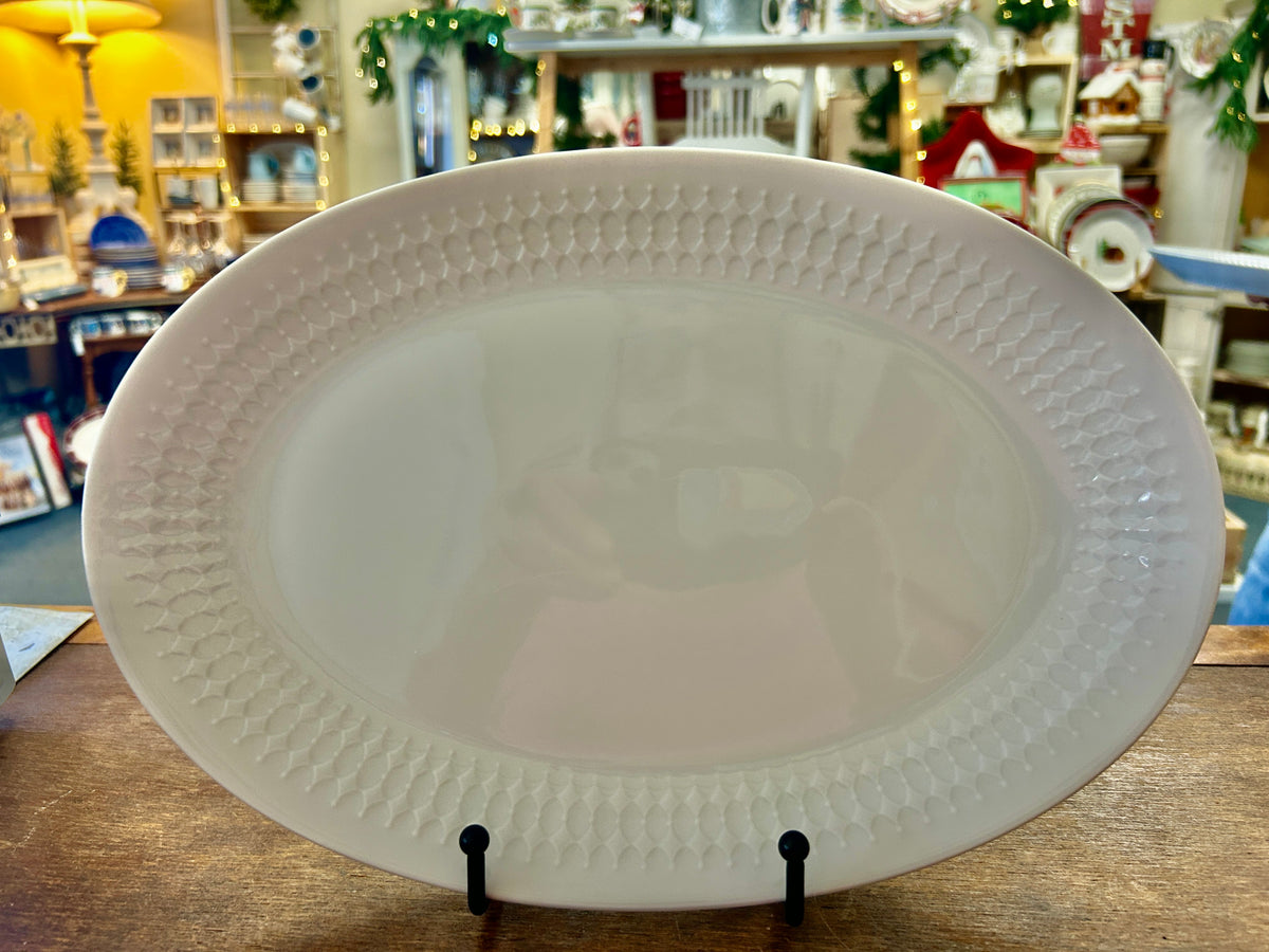 White oval serving platter with raised diamond texture rim