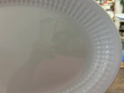 White oval platter close-up of raised diamond texture