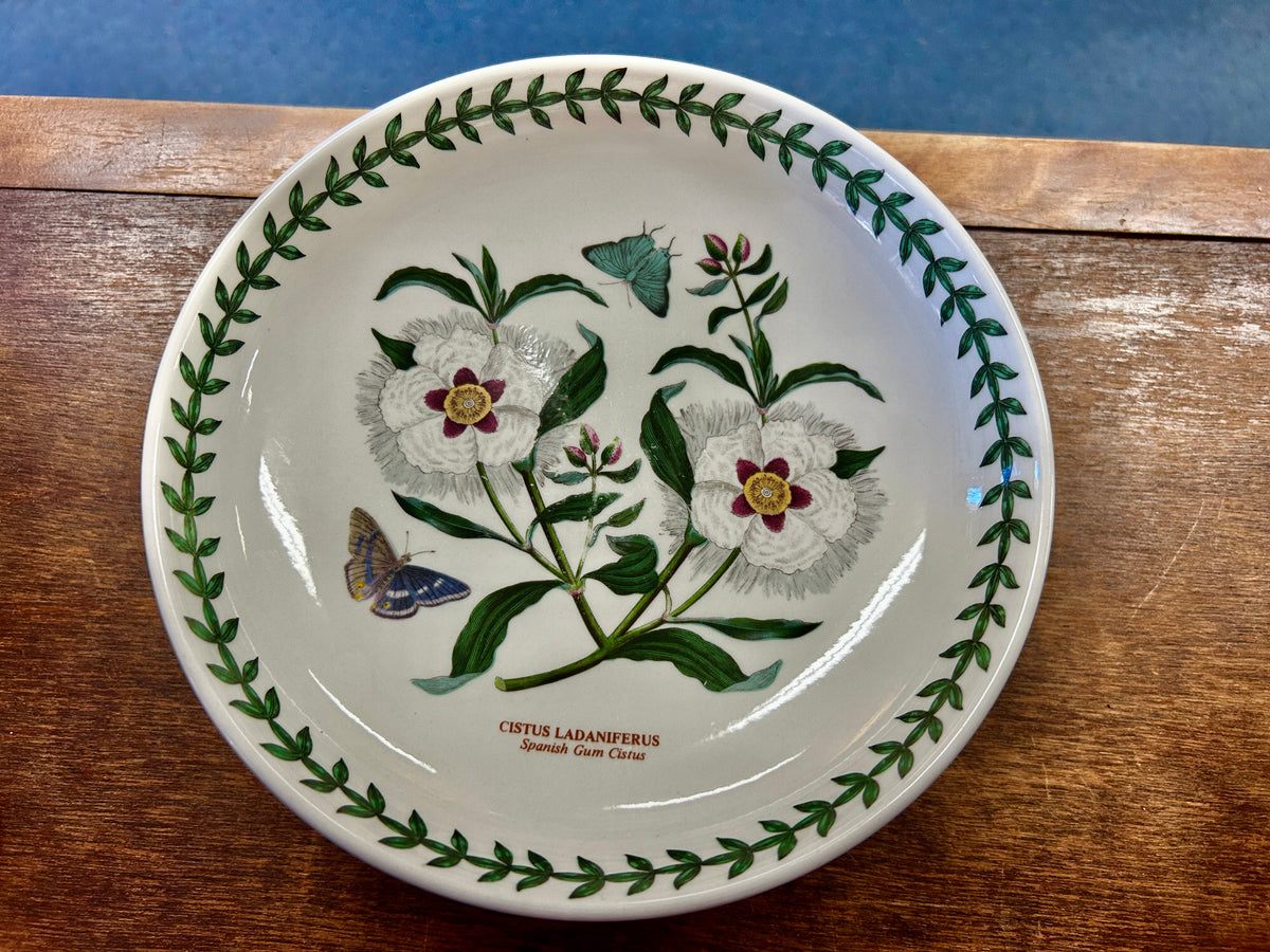 Ceramic footed bowl with wildflower-and-butterfly print and green leaf border
