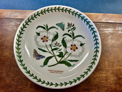 Ceramic footed bowl with wildflower-and-butterfly print and green leaf border
