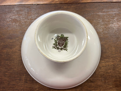 Bottom of ceramic footed bowl with printed emblem on white base