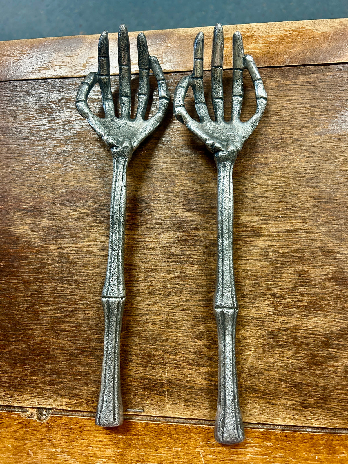 Silver skeleton hand forks, 2 pcs, long tines and curved handles.