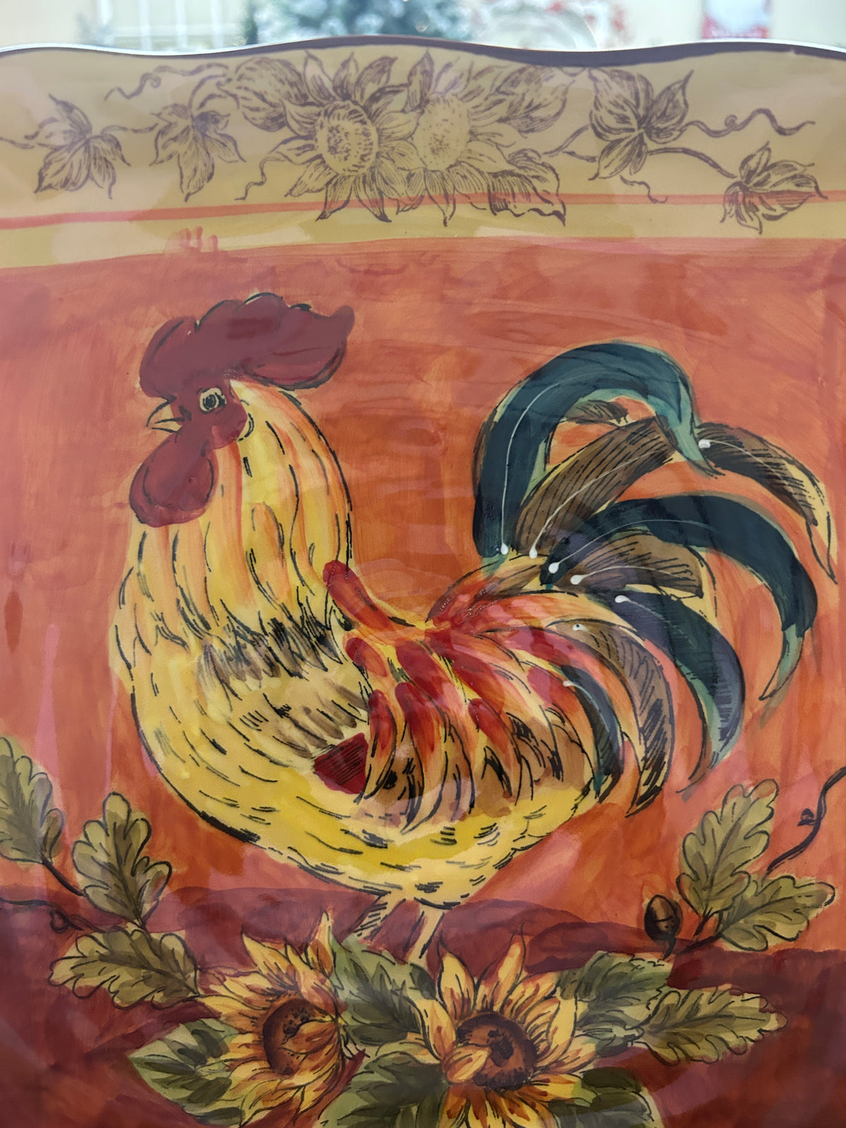 Orange and yellow rooster square platter featuring detailed rooster with floral accents.