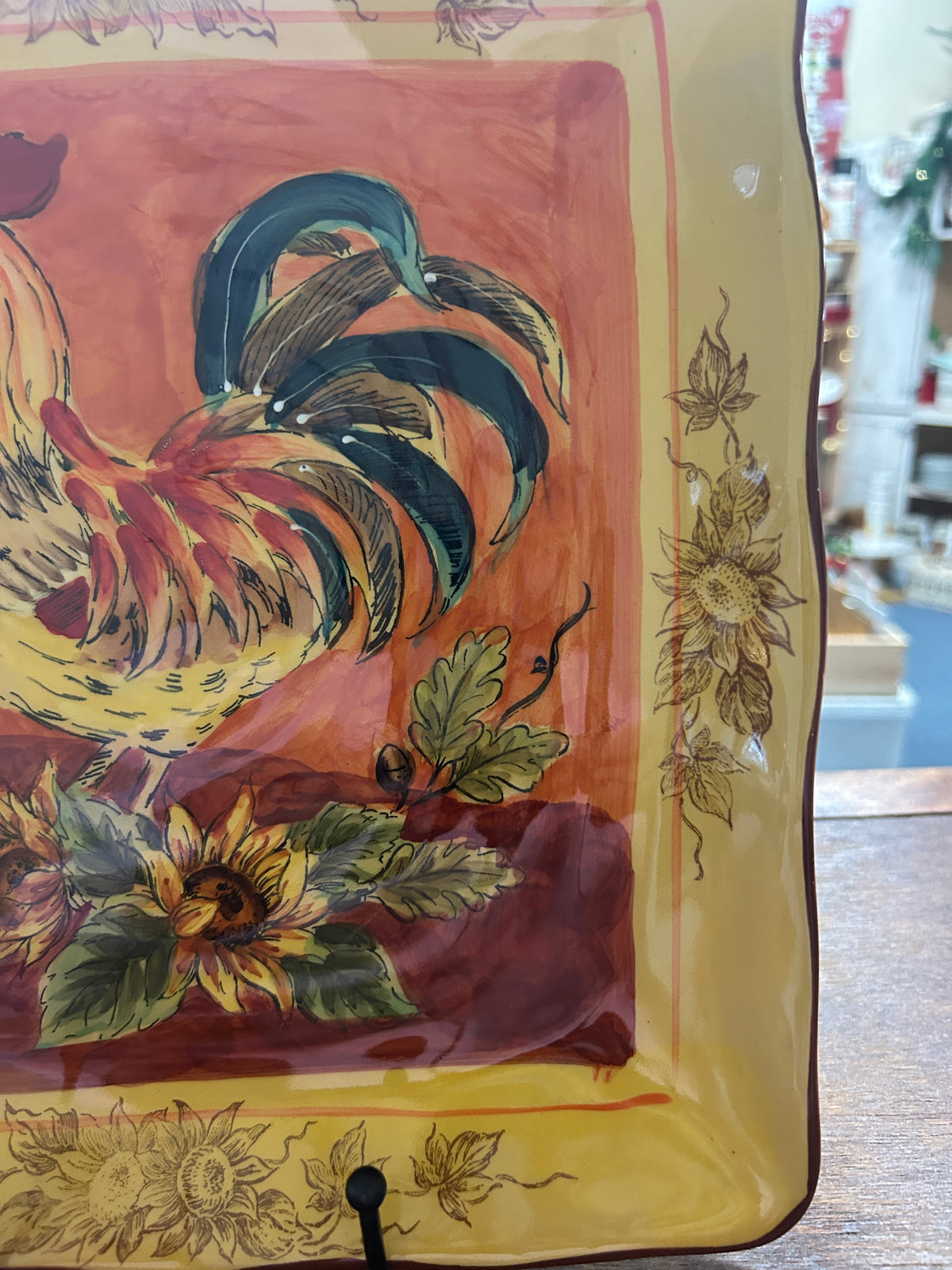 Orange and yellow rooster square platter angled view showing rooster, flowers, and trim.