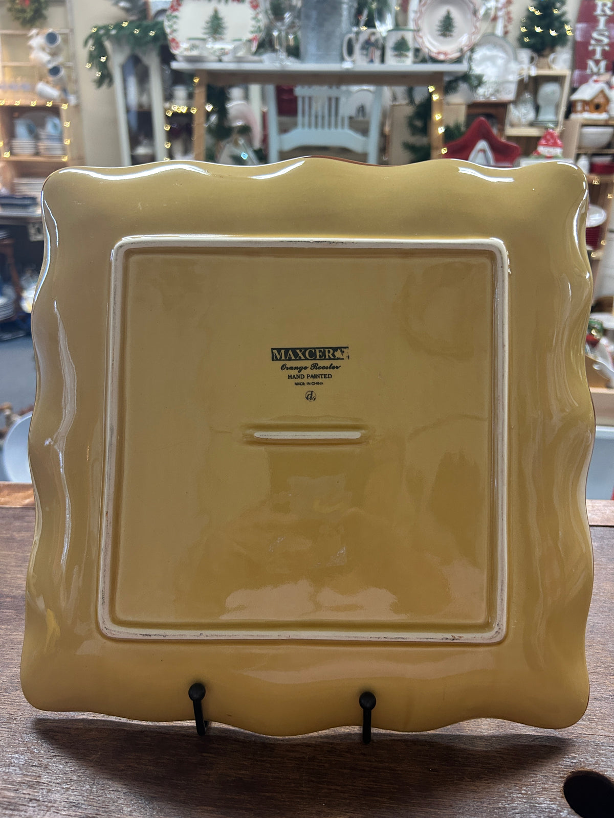 Glossy orange and yellow square platter back with Maxcera logo and molded details.