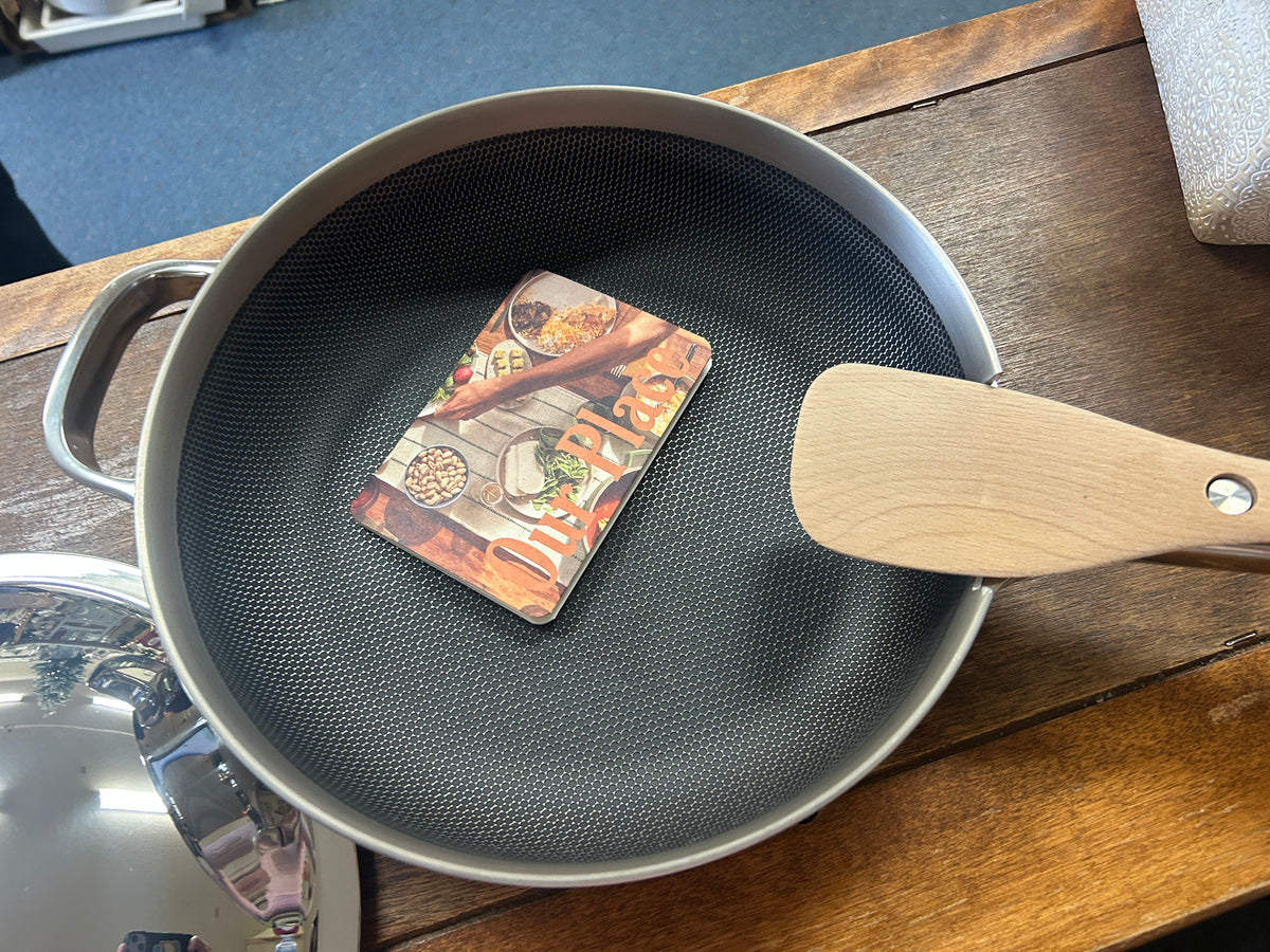 Dark nonstick skillet interior with wood handle and rivet