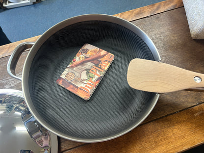 Dark nonstick skillet interior with wood handle and rivet