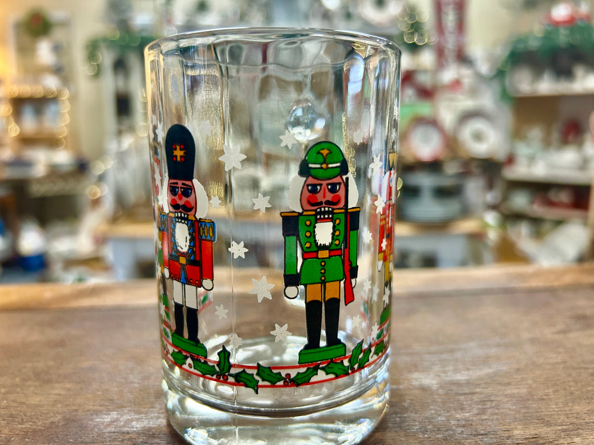 Holiday nutcracker glass mug showing two nutcracker character prints on front