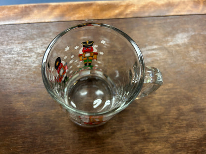Glass mug bottom interior view with small nutcracker print near rim