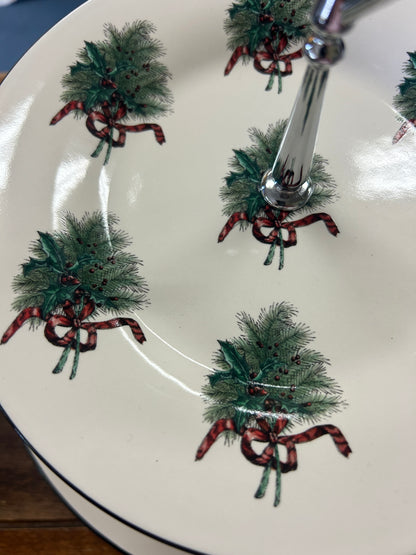 White plate with green wreath and red bow motif around chrome center post
