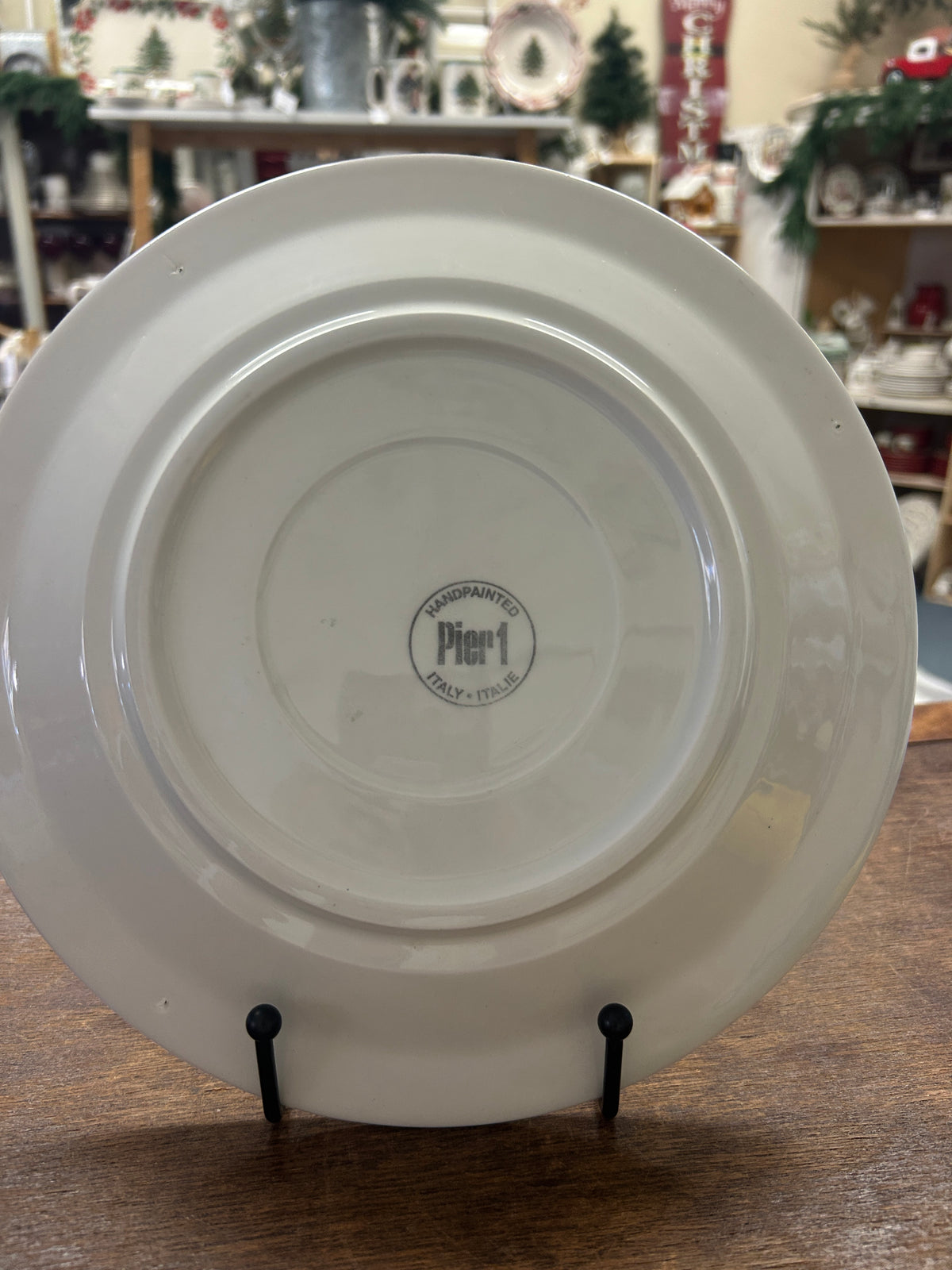 White back plate with Pier One logo and two black display stands