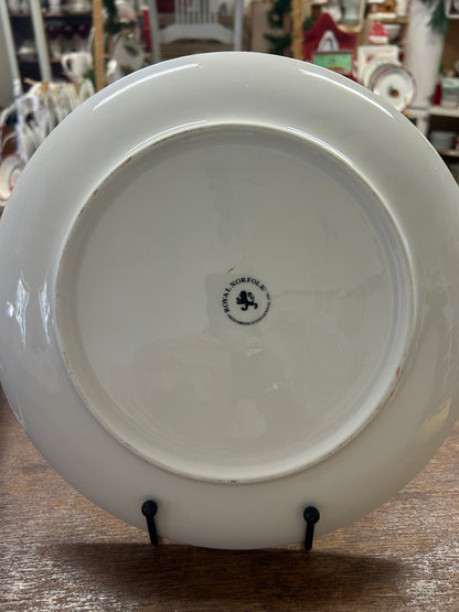 White porcelain plate base with brand mark in center, round serving dish