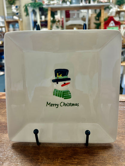 White square Christmas plate with snowman cut-out and “Merry Christmas” text